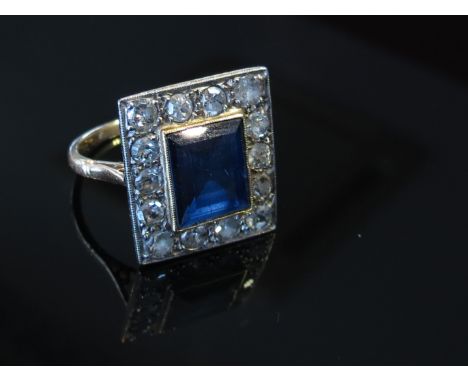 A sapphire and diamond deco ring the central sapphire 10mm x 8mm framed by 14 brilliant cut diamonds, size O, 4.4g