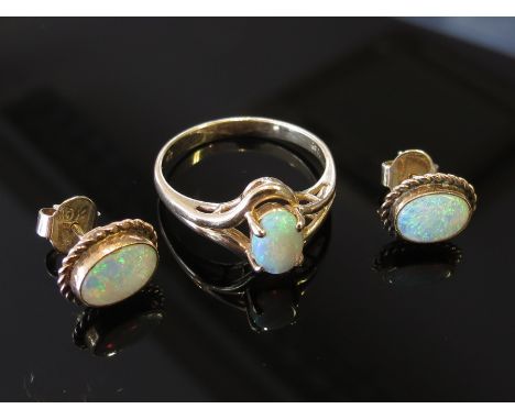 A gold ring set with an opal stamped 9ct, with a pair of 9ct gold opal stud earrings, size O, 4g total