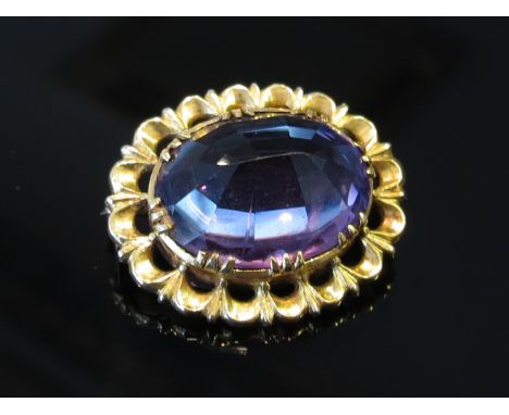 An amethyst brooch with pierced yellow metal mount