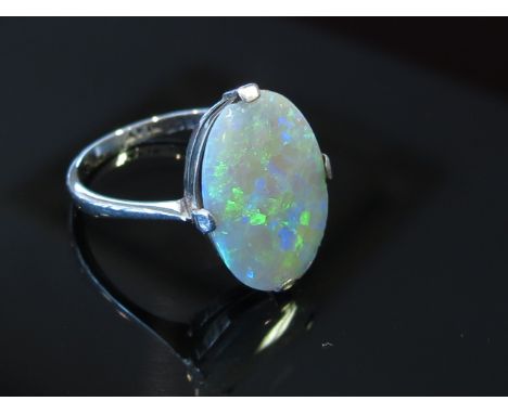 An 18ct white gold platinum set oval opal ring. Size L, 2.3g