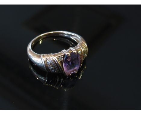 A 9ct gold ring set with central oval amethyst, diamond chips to shoulders, size L, 3g