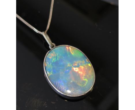 An oval opal pendant, 25mm x20mm, hung on chain