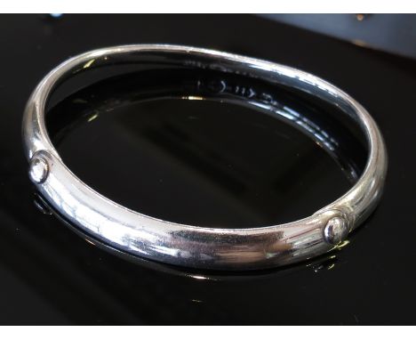 A George Jensen stiff hinge bangle "button" design, boxed and stamped