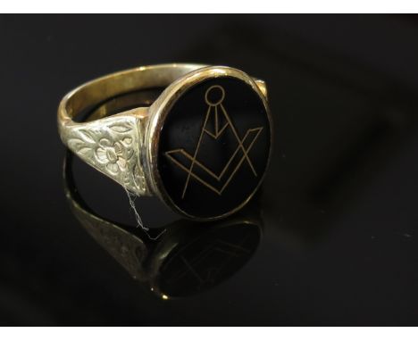 A 9ct gold Masonic signet ring with floral engraved shoulders sized R, 3.3g 