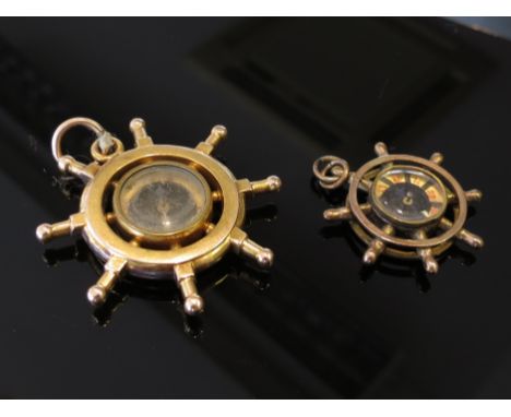 Two pendant compass and a ships wheel, unmarked, 11.9g