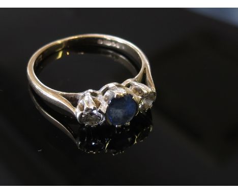 A 9ct gold sapphire and diamond ring the central sapphire flanked by diamonds, size I, 1.4g