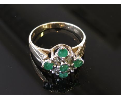 A 9ct gold emerald and diamond cluster ring, size P, 3.1g