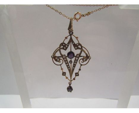 An Edwardian seed pearl and amethyst pendant/brooch stamped 9ct hung on chain