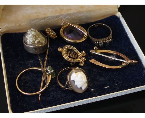 A box of gold items including cameo stick pin, amethyst and seed pearl brooch, wishbone brooch, pendant, rings etc, some a/f