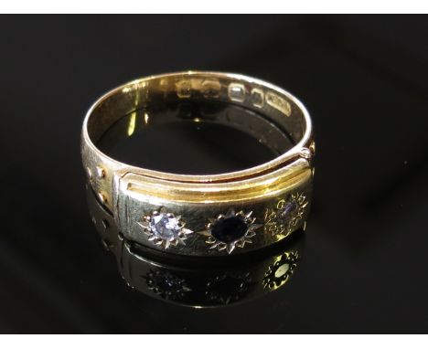 A gold ring set with sapphire flanked by diamonds the front opening to reveal "John", size P, marks rubbed, 5g