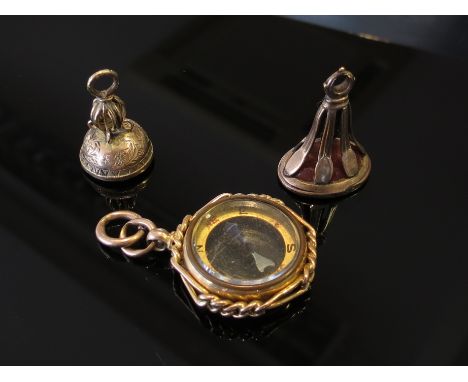 A 9ct gold compass pendant and two cornelian seal fobs, one with weeping willow motif, 11.8g (3) 