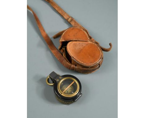 A Barker's Patent brass and black enamel prismatic compass, dated 1910, within a fitted leather case  By repute, this compass