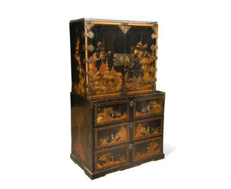 A Chinese Export gilt and black lacquer cabinet, on associated japanned chest of three drawers, the cabinet with a later bras