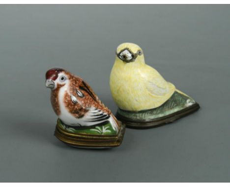An 18th century Bilston enamel and metal mounted snuff box, modelled as a canary, 6cm wide; a continental porcelain and metal