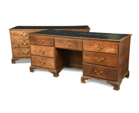 A pair of late 18th century oak estate desks, with inset tops, above seven drawers around a central recessed cupboard, brass 