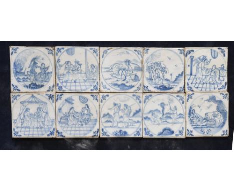 A set of twenty-five 18th century Delft blue and white tiles, probably Bristol, each depicting a biblical scene, within a dou