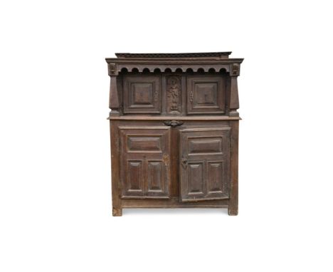 A 17th century carved oak court cupboard, the recessed upper part with arcaded frieze and bearing the date 1656, enclosed by 