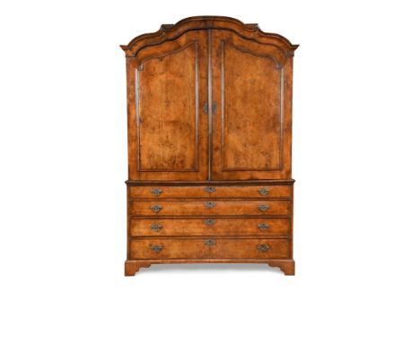 A 19th century Dutch walnut armoire, with arched figured panelled doors above four long drawers to the base, on bracket feet 