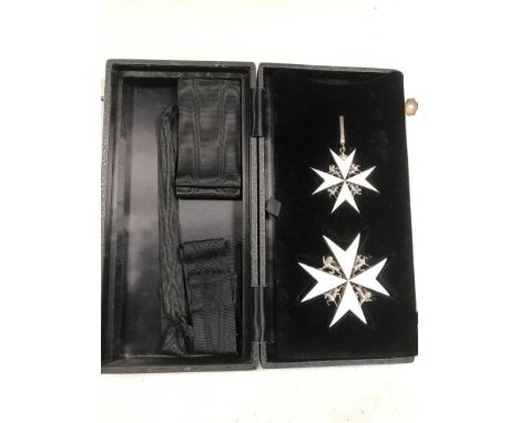 A Breast Star and Neck Badge of an Officer of the Order of the Hospital of St John of Jerusalem, white enamel on a black ribb