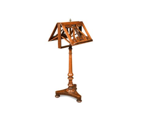 A Regency rosewood duet music stand, with fret carved lyre decorated music rests, on a turned column and pineapple finial 110