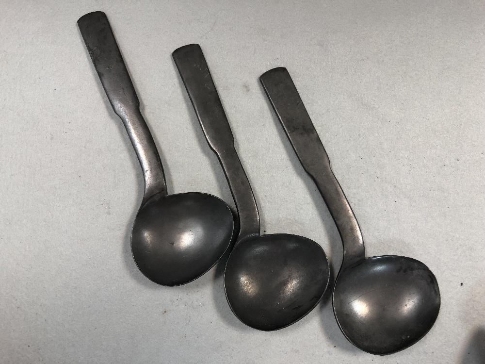 A set of three pewter shaped serving spoons, in Cheffins Fine Art