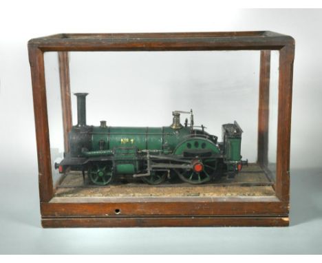 A mid-Victorian live steam model locomotive with open cab, painted in green and black livery and borne on an arrangement of t
