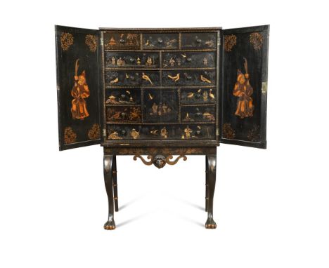 An 18th century Chinese lacquer cabinet on a later stand, fitted with twelve drawers and a small cupboard, enclosed by two do