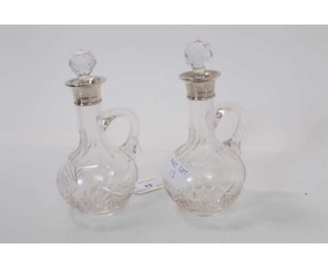 Pair George V silver mounted cut glass bottles, (London 1929), maker Henry Hobson &amp; Sons, each 17cm highOverall both bott