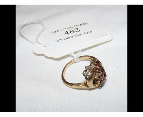 A lady's red stone dress ring in gold mount 