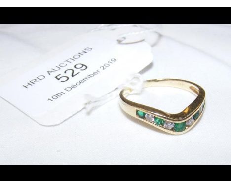 An emerald and diamond ring in 14ct gold setting 