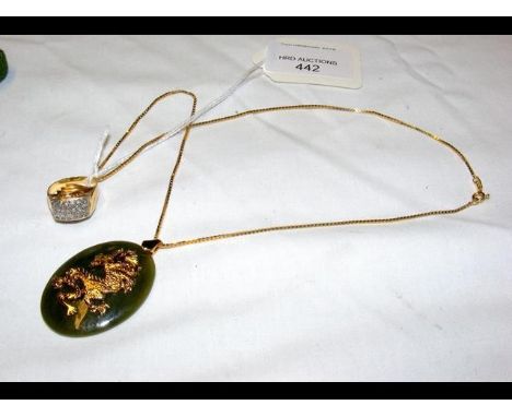 An oriental jade pendant with yellow metal dragon mount and chain, together with a ring 
