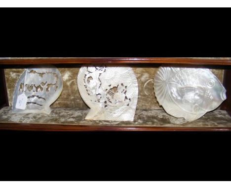 Three intricately carved old oyster shells 