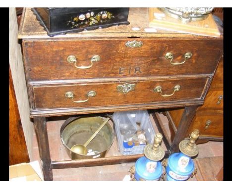 A Georgian oak two drawer chest with 'E I R' inscribed to the front 