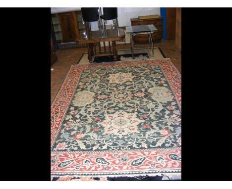 A large Middle Eastern style carpet with geometric border and green ground - 355cm x 260cm CONDITION REPORTseems in ok condit