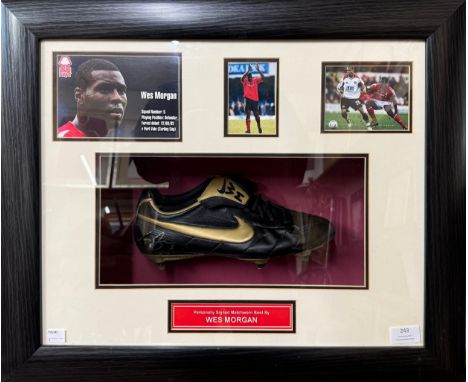 A matchworn and signed football boot, worn by Wes Morgan, in framed display