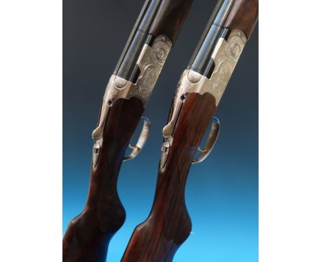 A pair of Beretta Silver Pigeon 687/3 20 bore shotguns numbered 1 and 2 with fine scrolled engraving around scenes of game bi
