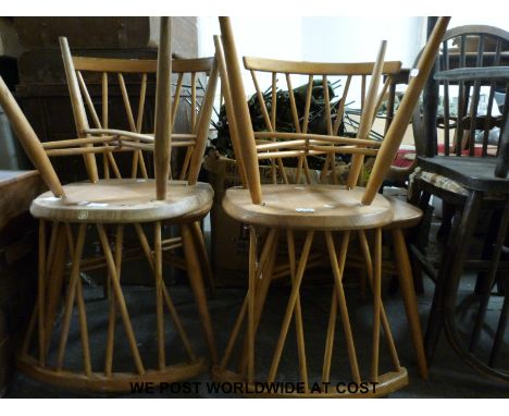 A set of four Ercol light elm stick back dining chairs