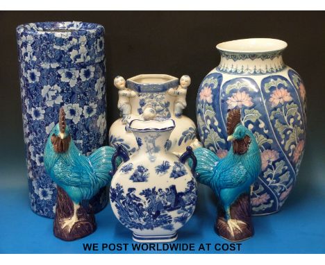 A collection of decorative blue & white vases, an umbrella stand, ceramic cockerels etc.