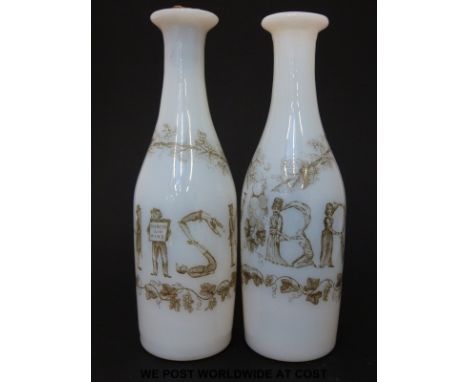 A pair of Richardsons opaline glass spirit decanters of slender farm decorated in enamel with the words 'Brandy' and 'Whisky'