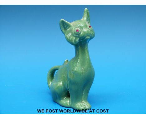 An Arts & Crafts ceramic cat with glass eyes