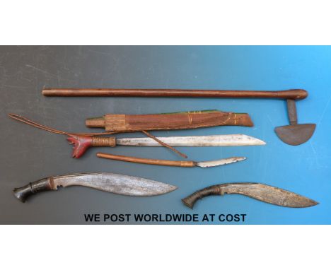 Two kukris, a probably tribal axe and a tribal knife with further knife attached