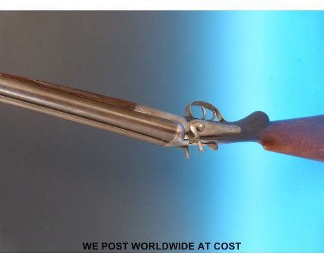 Unnamed 12 bore double barrelled side by side hammer action shotgun with engraving to the side locks and chequered semi-pisto