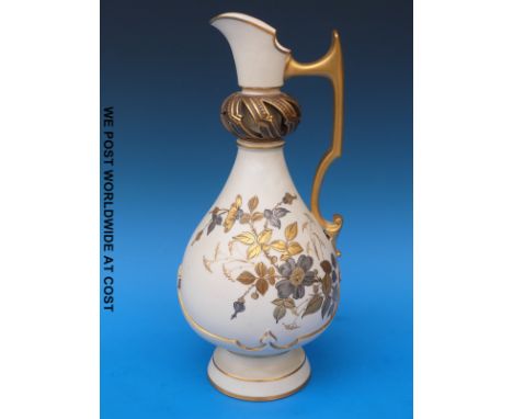 A Royal Worcester ivory ground ewer with applied gilded floral decoration and openwork neck (33cm tall)