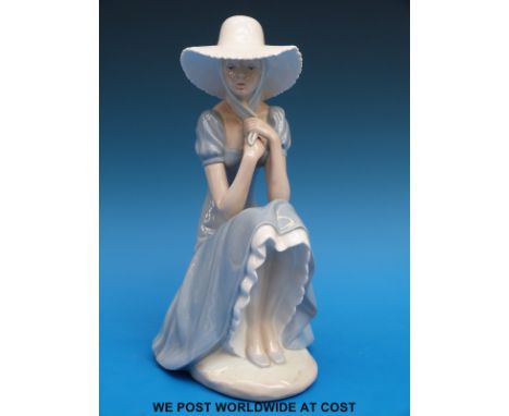 A Nao figurine of a girl in a sunhat (27cm tall)