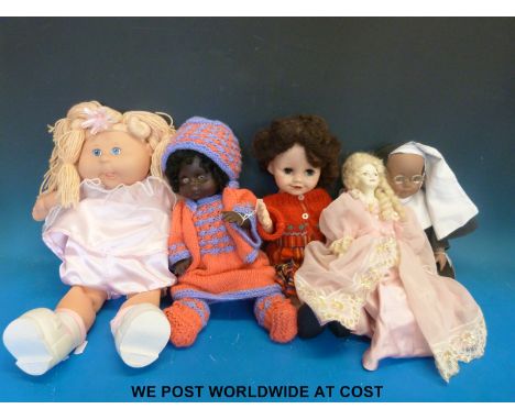 Five various dolls to include walking doll, Cabbage Patch doll, one in the form of a nun with a miniature bible, Topsie-turvi