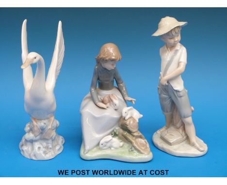 Nao figures including a child with catapult, girl with pet rabbits and a swan (tallest 21cm)