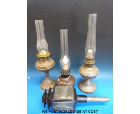Three brass/copper oil lamps and a coaching lamp