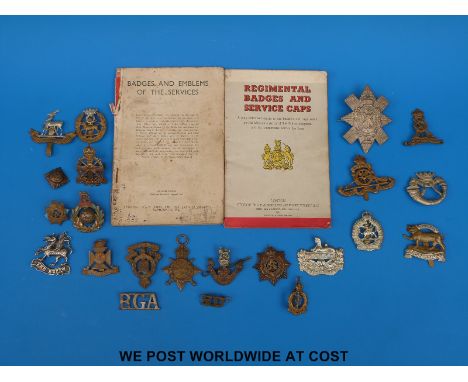 A collection of WWI and WWII military cap badges etc., to include Pioneer Corps Cornwall light infantry, Leicestershire, U.N 