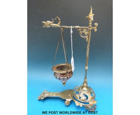 A brass hanging incense burner with griffin or phoenix head decoration and mask finial