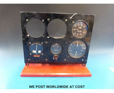 An aircraft instrument panel, possibly ex link trainer, the instruments sectioned to show working